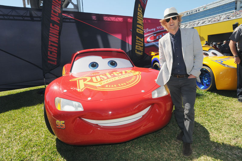 DAYTONA BEACH, FL - FEBRUARY 26: Grand Marshal Owen Wilson, voice of Lightning McQueen in "Cars 3" poses with Lightning McQueen for the 59th Annual DAYTONA 500 at Daytona International Speedway on February 26, 2017 in Daytona Beach, Florida. (Photo by Gerardo Mora/Getty Images for Disney) *** Local Caption *** Owen Wilson